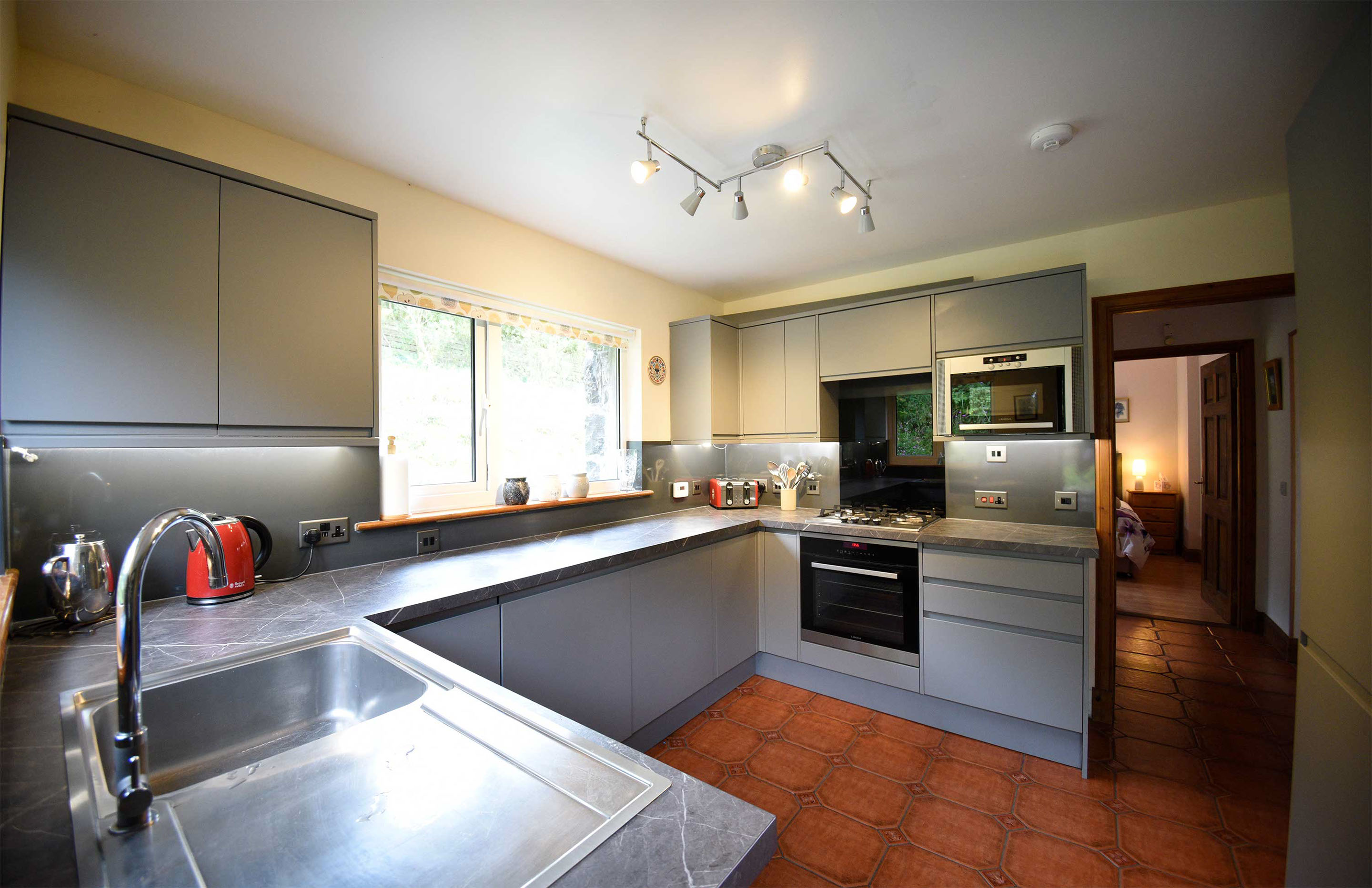 Auld Orwell Cottage kitchen contains oven hob microwave kettle toaster dishwasher and washing machine