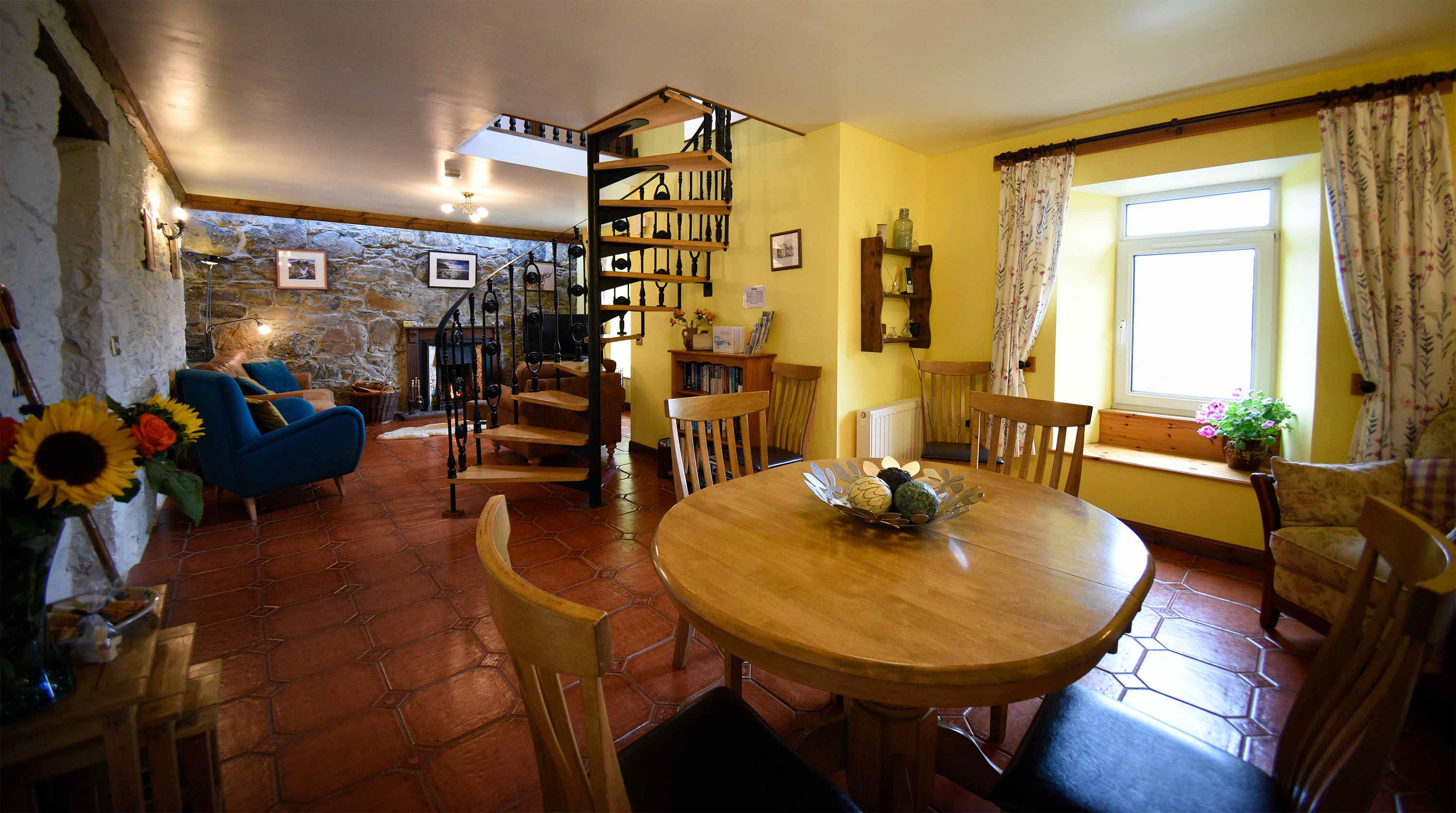 Open plan living and dining room at Auld Orwell Cottage with cosy open fireplace WIFI internet and sea views